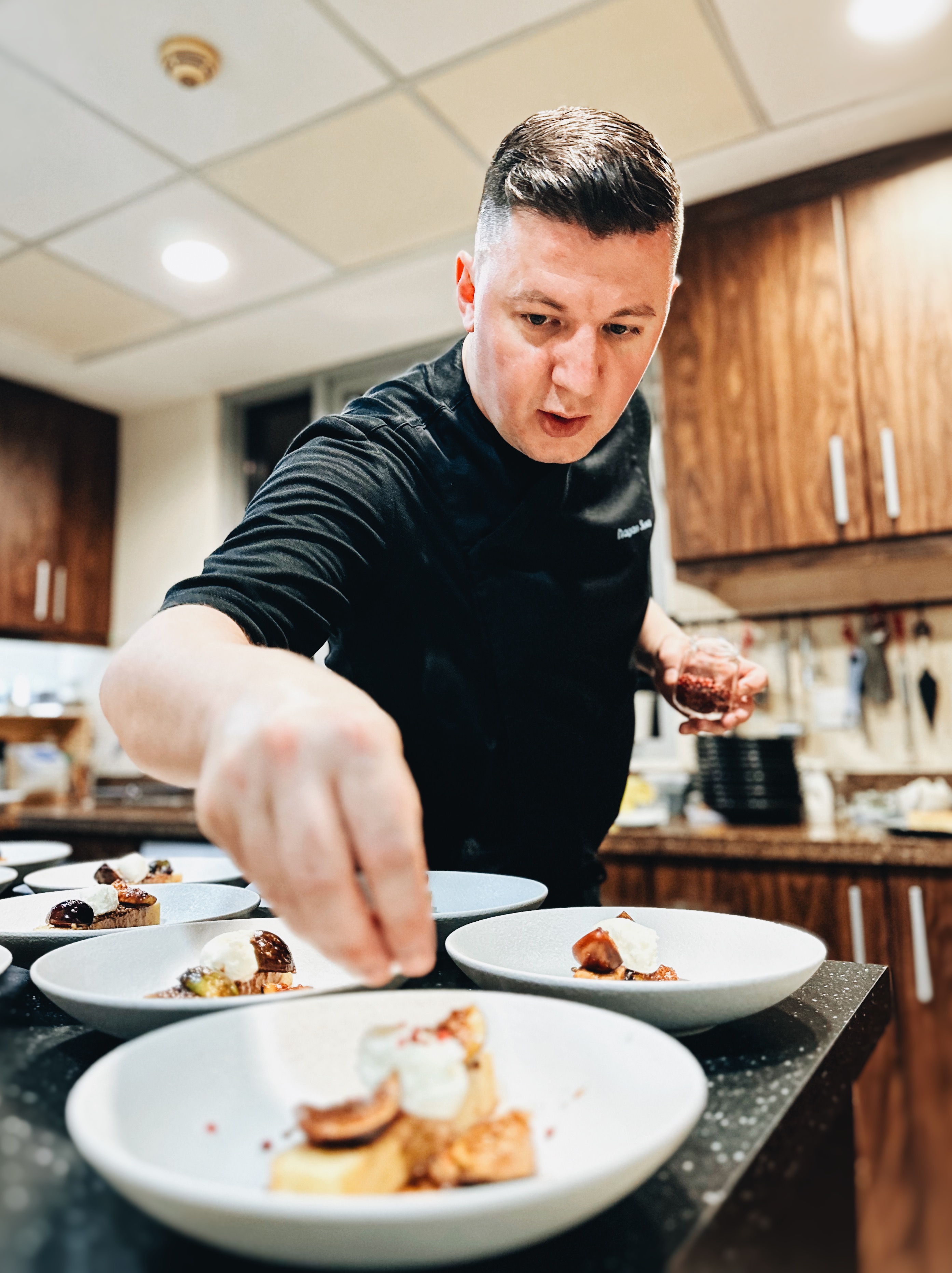 Chef Dragan Susa plating dishes for a private dining experience in Dubai
